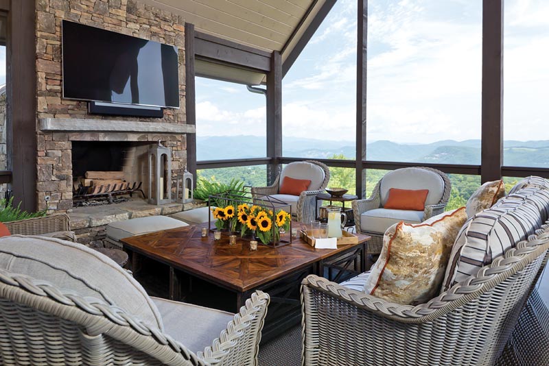 Outdoor seating with a flat screen TV and view of the mountains
