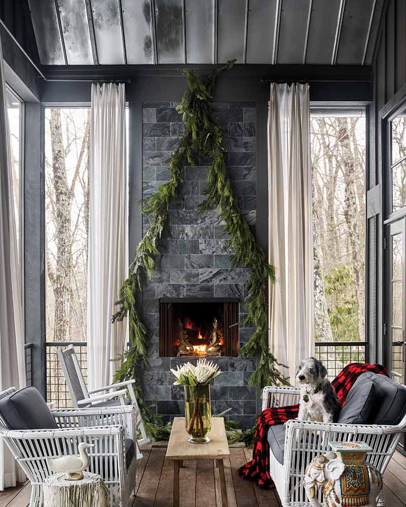 tin ceiling, fireplace, and white rattan furniture on close-in porch